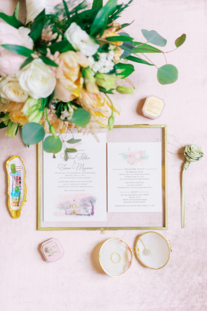 A watercolor wedding invitation featuring the couple's wedding venue illustration.